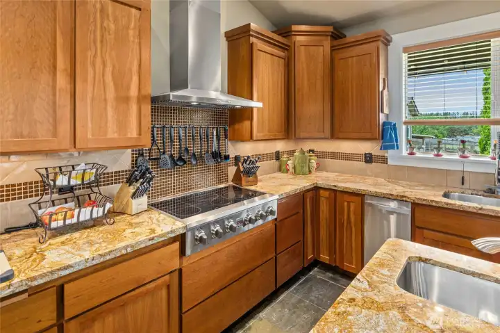 Solid cherry cabinets and granite countertops!  Electric range,  Huge island, Double Door pantry, warming drawer, compactor and more!