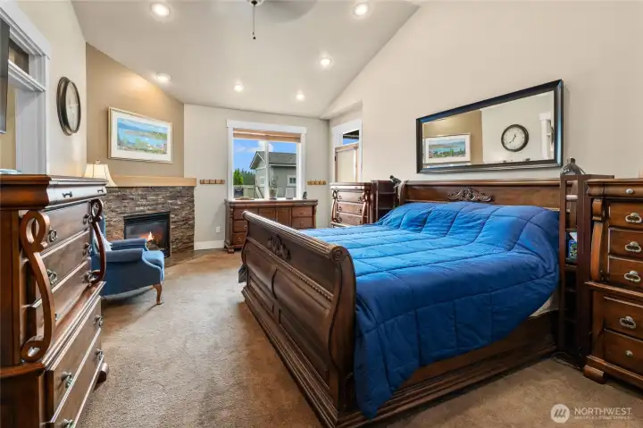 Vaulted light and bright primary suite with propane fireplace walk-in closets and 5 piece bath!