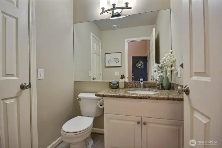 The well-located main-level powder room adds everyday functionality and easy accessibility for guests The well-located main-level powder room adds everyday functionality and easy accessibility for guests