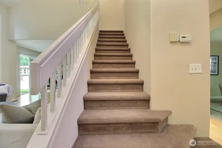 The open staircase flanks the living space offering easy access to the second floor. The open staircase flanks the living space offering easy access to the second floor.