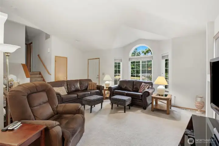 Main level living room is spacious and features multiple windows, allowing for an abundance of natural light to fill the open floor plan. This inviting space serves as the heart of the home, offering both functionality and comfort, and provides the perfect backdrop for hosting guests or enjoying quiet evenings. With its generous layout and airy atmosphere, this living area seamlessly connects to the rest of the main level, creating an ideal environment for modern living. Main level living room is spacious and features multiple windows, allowing for an abundance of natural light to fill the open floor plan. This inviting space serves as the heart of the home, offering both functionality and comfort, and provides the perfect backdrop for hosting guests or enjoying quiet evenings. With its generous layout and airy atmosphere, this living area seamlessly connects to the rest of the main level, creating an ideal environment for modern living.