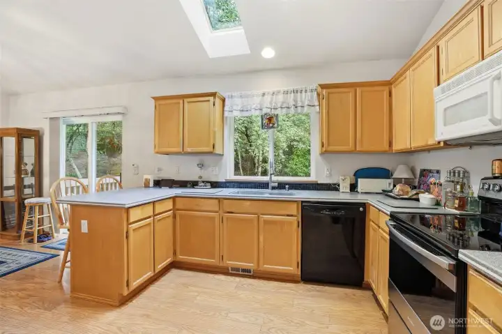 Check out this bright, kitchen! Updated countertops and an overhead skylight that brings in natural light. Please be aware that the pantry is conveniently located is not visible in this photo. Check out this bright, kitchen! Updated countertops and an overhead skylight that brings in natural light. Please be aware that the pantry is conveniently located is not visible in this photo.