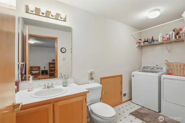 Lower level half bathroom with laundry and storage area. Lower level half bathroom with laundry and storage area.
