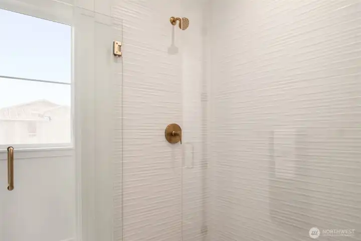 Oversized tile shower with frameless glass enclosure Oversized tile shower with frameless glass enclosure