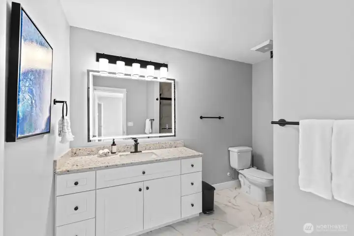 Large ensuite bath with a custom tiled shower.