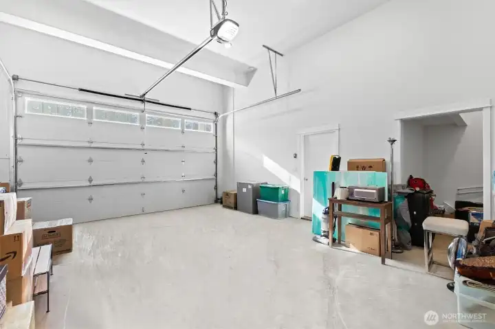 Oversized garage with a custom 10' garage door to store your camper van, and additional storage space where you will find the water heater.