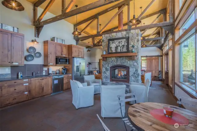 The massive double sided fireplace warms the Lodge lounge area and the kitchen.