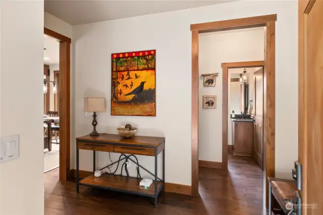 Handcrafted wood floors throughout the home create a cozy and inviting atmosphere. Just off the entry, you'll find a convenient half bath and the laundry room.