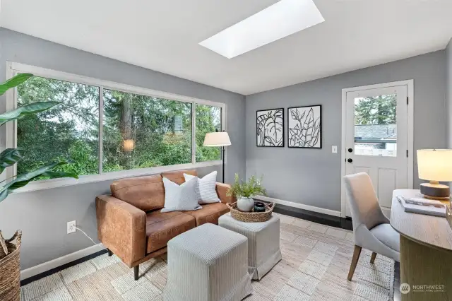 Flex room with skylight, enormous windows and   exterior door leading to the private deck.