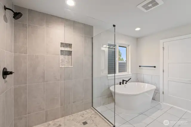 Primary bath with large party shower and soaking tub as well as heated floors
