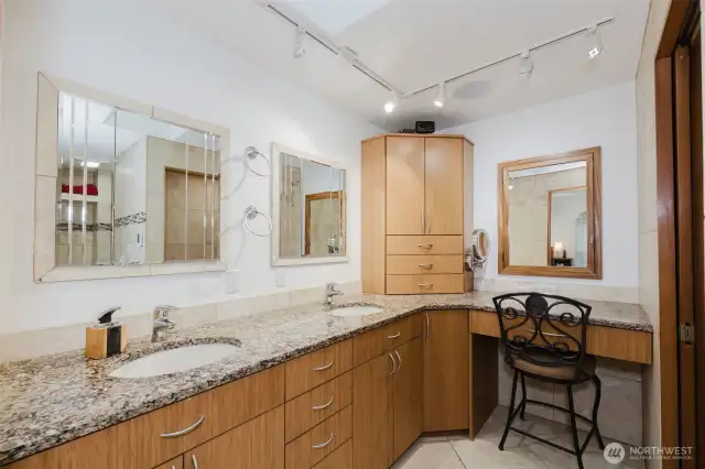 Indulge in the spacious primary bathroom featuring sleek granite countertops, abundant lighting, and generous storage—where everyday convenience is blended with a beautifully-designed retreat.