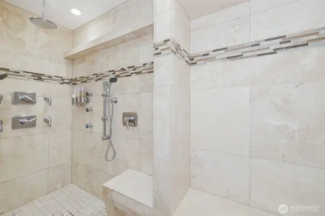 Step into the expansive, tiled shower where clean lines & ample space create a spa-inspired escape designed for ultimate relaxation.