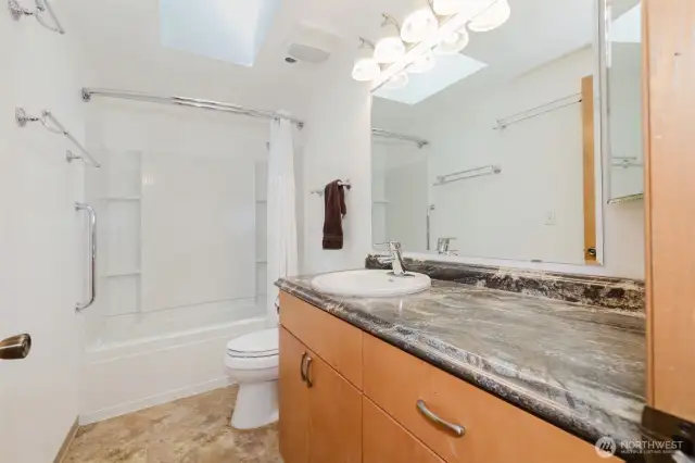 Another sunlight-soaked bathroom offers a balance of brightness & functionality...