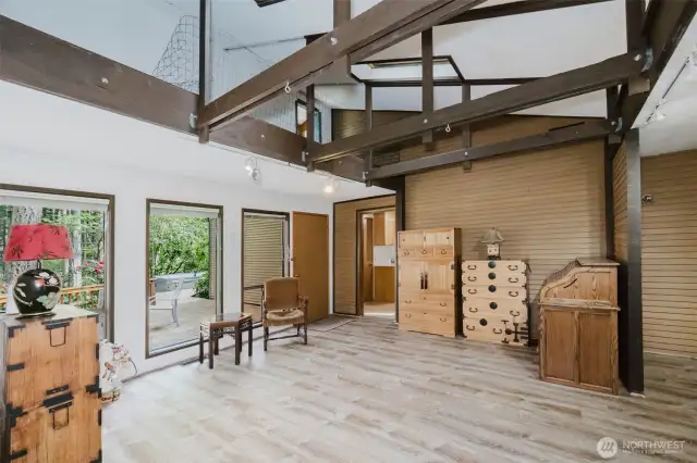 Airy, open-beam ceilings elevate the space, adding charm and a cozy feel.