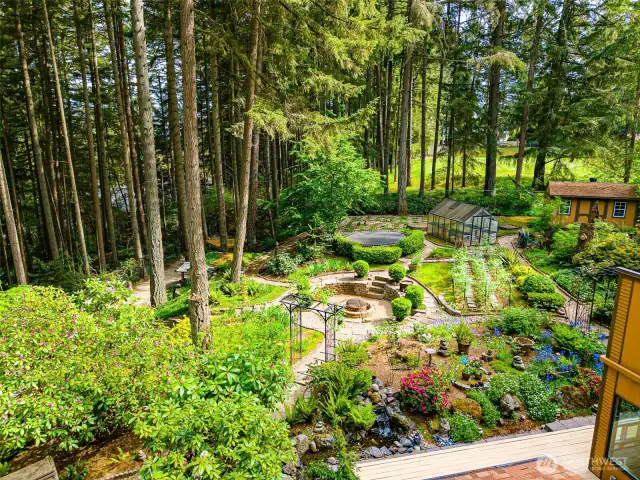 The expansive outdoor grounds feature a cozy fire pit, functional greenhouse, fun-filled trampoline, and a shed—all nestled amid mature trees and lovely shrubbery, offering the perfect blend of recreation and relaxation.