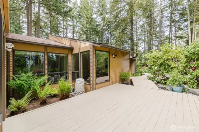 The patio extends further, leading to a quaint stepping bridge that gently adds a touch of charm!