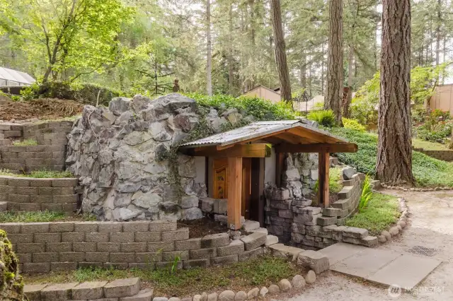 This whimsical outdoor wine cellar, hand-dug with meticulous care, creates a one-of-a-kind space that feels like a hidden treasure—perfect for wine lovers seeking a unique and charming retreat in the heart of nature!