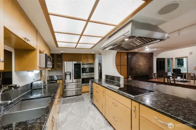 High-end Wolf stainless steel appliances and ample cabinetry make this kitchen a chef's dream!
