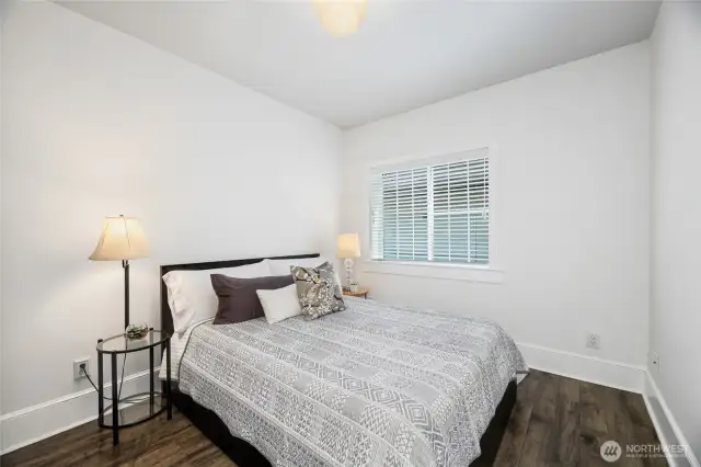 3rd Bedroom shown with Queen Size Bed has mirrored closet doors. It is just across from a bathroom and other bedroom.