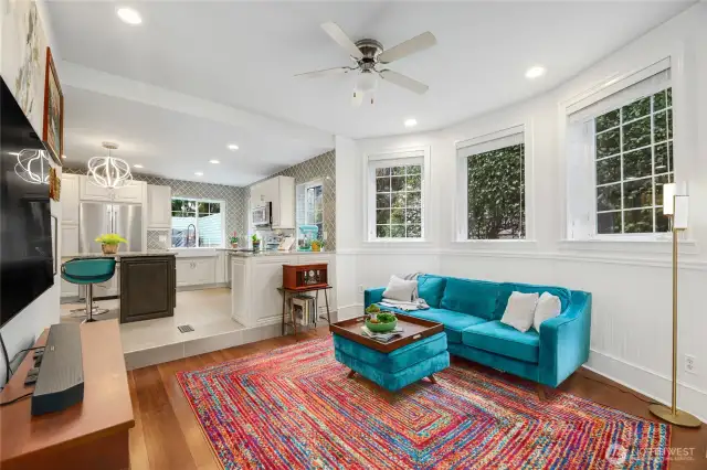 Just off the luxurious kitchen is this inviting living room with gas fireplace and an abundance of windows for natrual light.  Ceiling fan can also keep air conditioning or heating efficient.