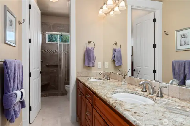 Hall bath with double sinks, tile shower