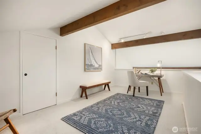 Upstairs loft makes a perfect office space, craft room or exercise area. Door goes into a large storage area!