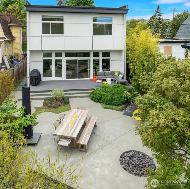 Welcome to your world.  Beautifully integrated outdoor design with multiple seating areas, fire pit, water feature, and specimen plantings.