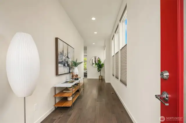Entry gallery hallway leads to the open main floor living space.