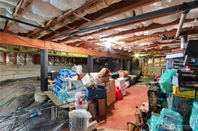 As you come down the basement, to the left is this unfinished area perfect for extra storage. To the right is the finished area of the basement.