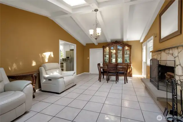 From the kitchen to your dining room and family room with wood fireplace. Exposed beams, vaulted ceiling, nice stone masonry around the fireplace.