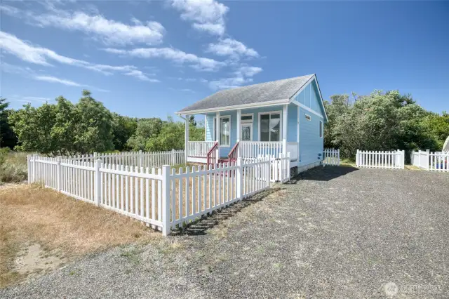This tiny home comes with a cute little yard, storage shed, and room for RV parking, with a 30 amp outlet on the side of the home for RV or EV.