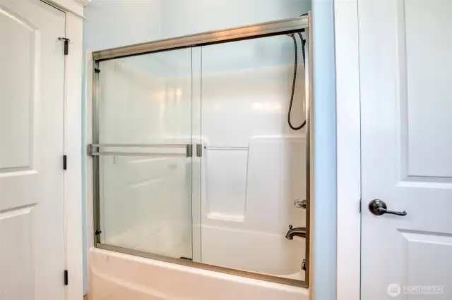 Tub/shower combo in the bathroom.