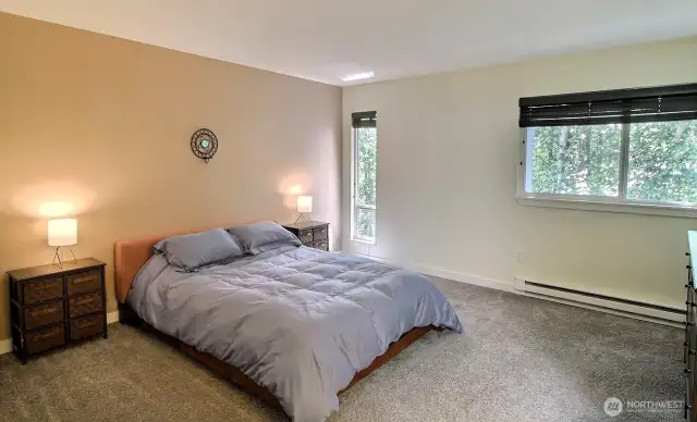 Generous primary bedroom featuring custom blinds.