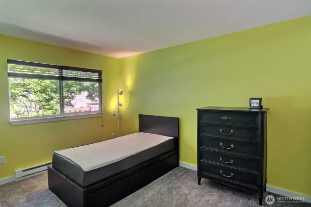 Bright  2nd bedroom with a large window, custom blinds for privacy and style, plus a good-sized closet for plenty of storage.