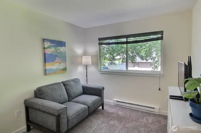 Cozy 3rd bedroom featuring soft natural light, custom blinds, and a spacious closet to keep things tidy.
