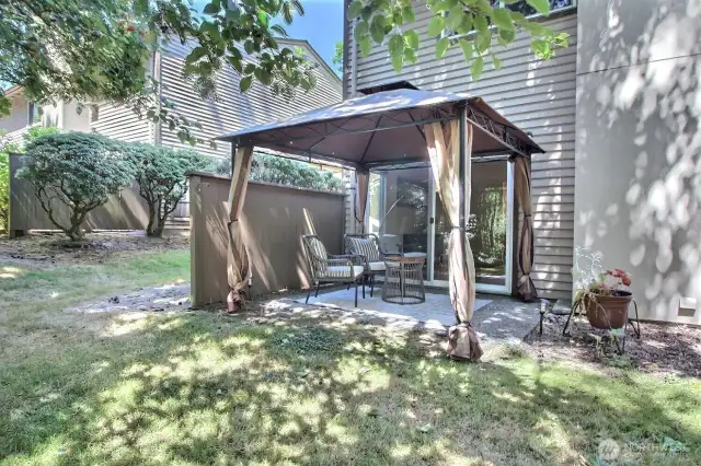 Secluded back patio area offering a peaceful retreat with serene views overlooking the lush woodlands.