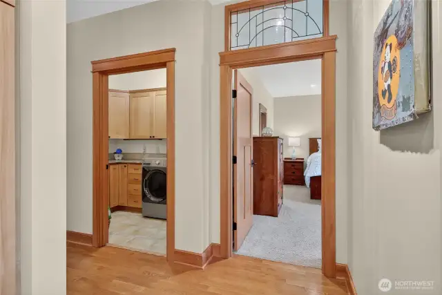 Laundry to the left, primary bedroom to the right. Notice the leaded glass details!