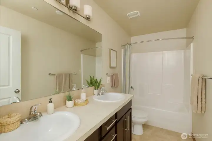 Main hall bath on the upper level. Photo has been virtually staged.