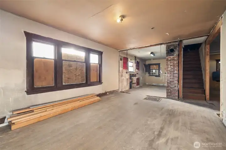 Living area flows seamlessly into the kitchen with access to the upstairs.