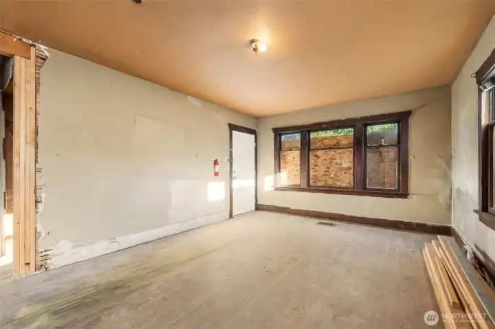 Living room features hardwood floors and classic window trim.