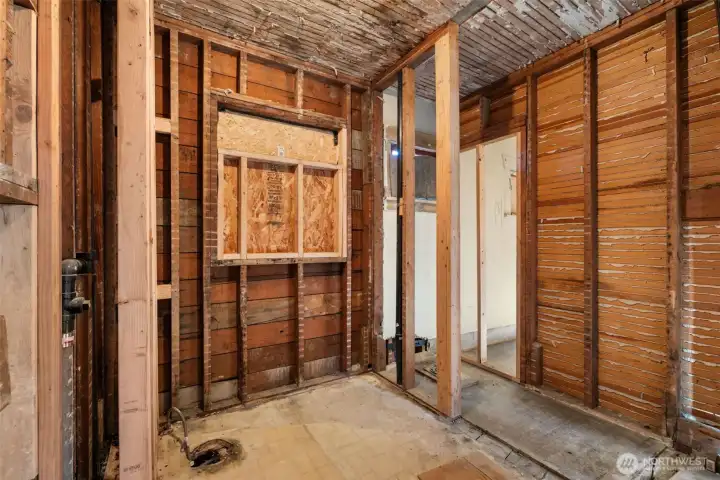 Plumbing roughed in and privacy window framing complete. Bath ready for your design.