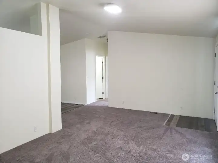 Huge Living Room with Newer Carpeting, Cathedral Ceilings, Newer Interior Paint. and Vinyl Plank Entry.