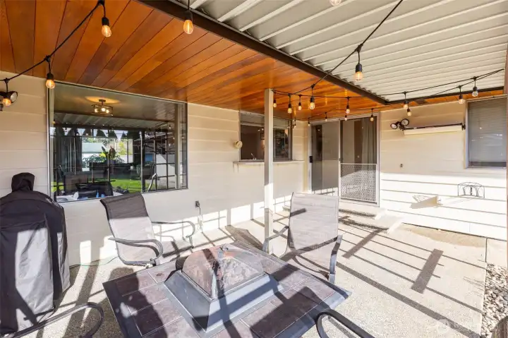 Covered, partially enclosed outdoor living area looks out to the large fenced backyard & is great for year round enjoyment.