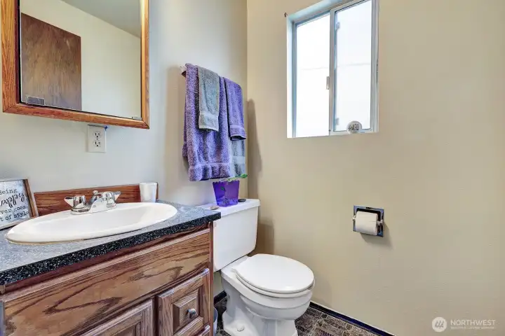Half bath on the main floor off the utility room for your convenience. Steps to the garage door access and to the front and side yards.