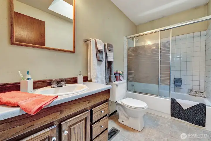 Full Guest bath on upper level has single sink vanity with cabinets and drawers for all your bathing needs.