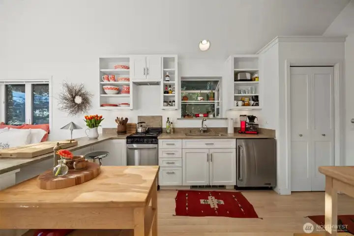 Looking at the kitchen with the pantry storage closet to the right and the eating bar to the left.