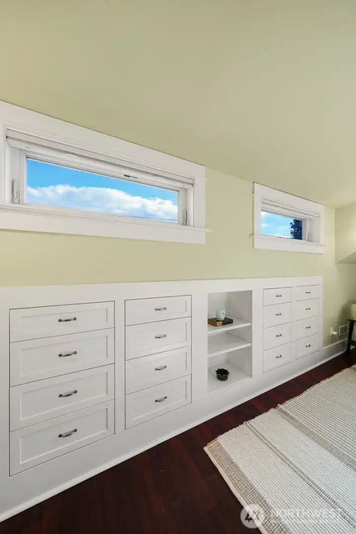 Primary bedroom with built-in storage and walk in closet (not shown)