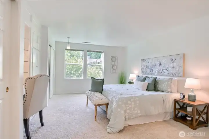 Large primary ensuite w/dual closets, custom built-ins & adjoining full bath.