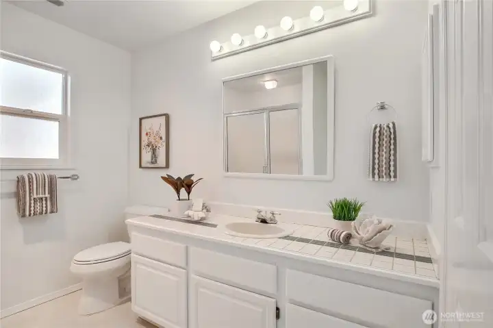 3/4 bathroom with newly painted cabinets.