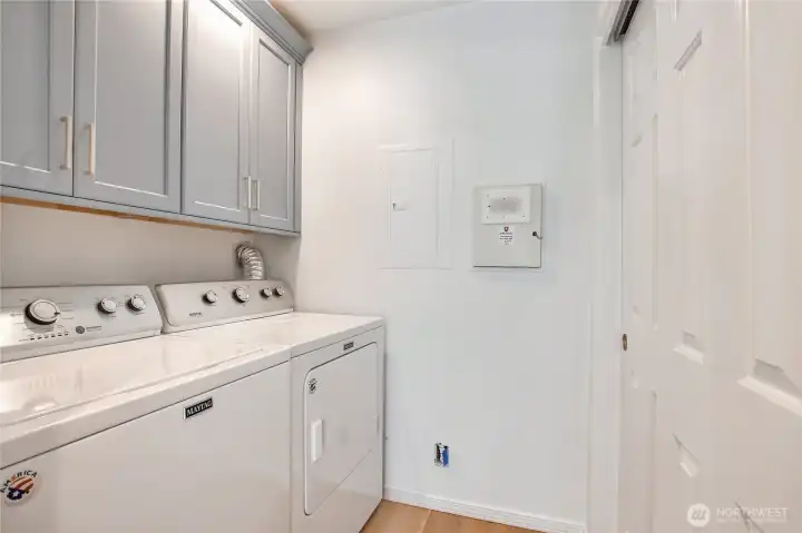 Walk-in laundry and cabinets for storage.